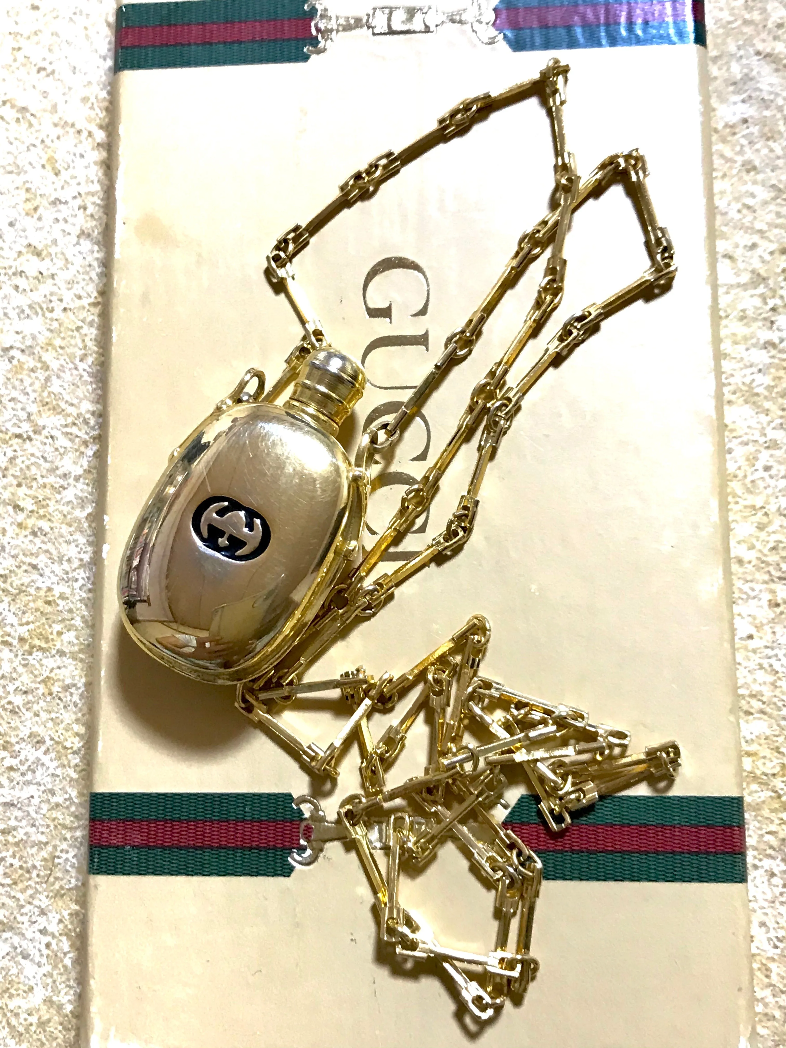 Vintage Gucci golden perfume bottle necklace with logo mark on top. Gorgeous rare masterpiece from 80's. 0410271